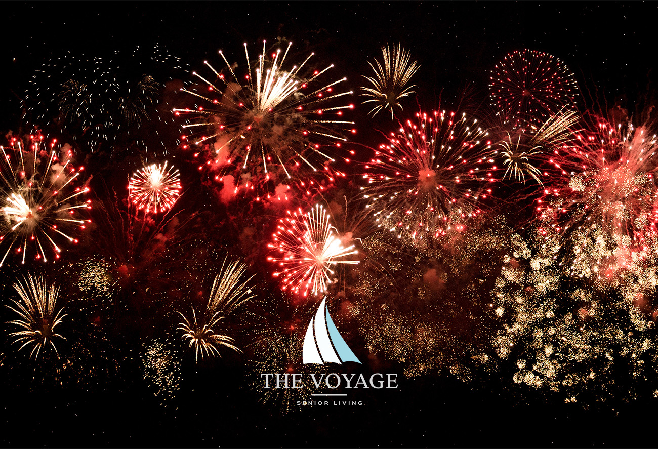 image of fireworks in the night sky, with the Voyage senior living logo